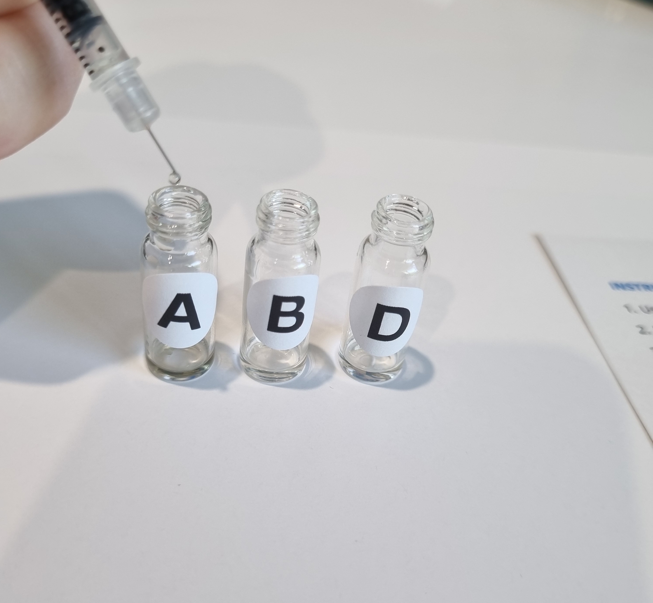 Applying sample to testing kit using a small needle